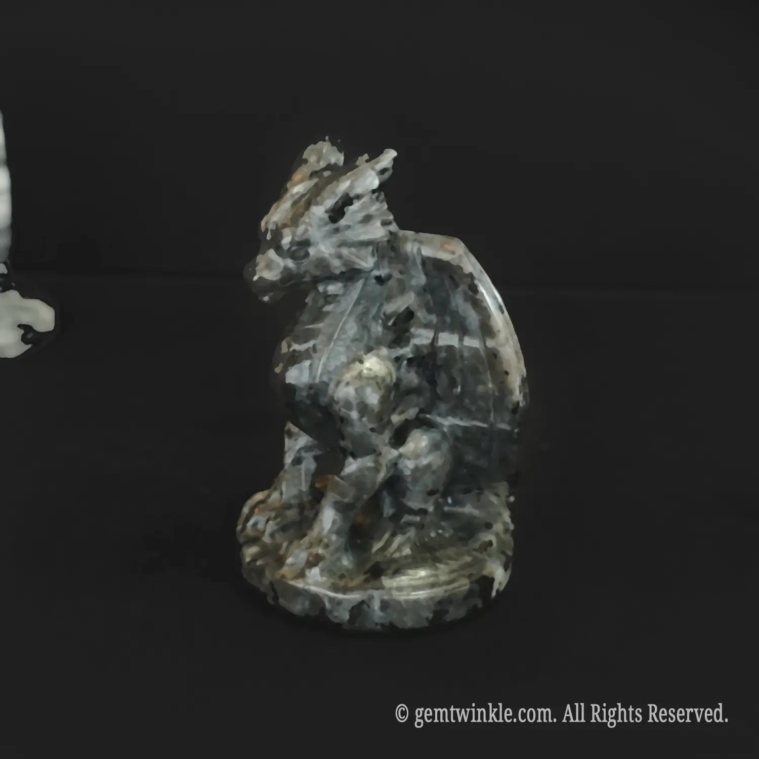 Grey spotted stone dragon figurine detailed view