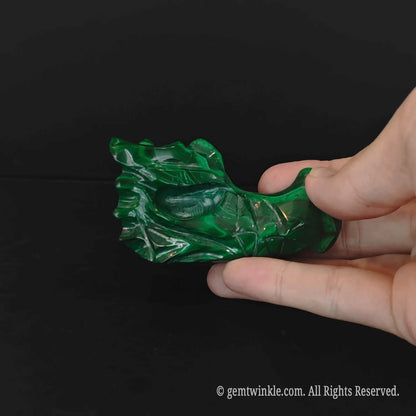 Handheld malachite dragon carving highlighting polish and green color intensity