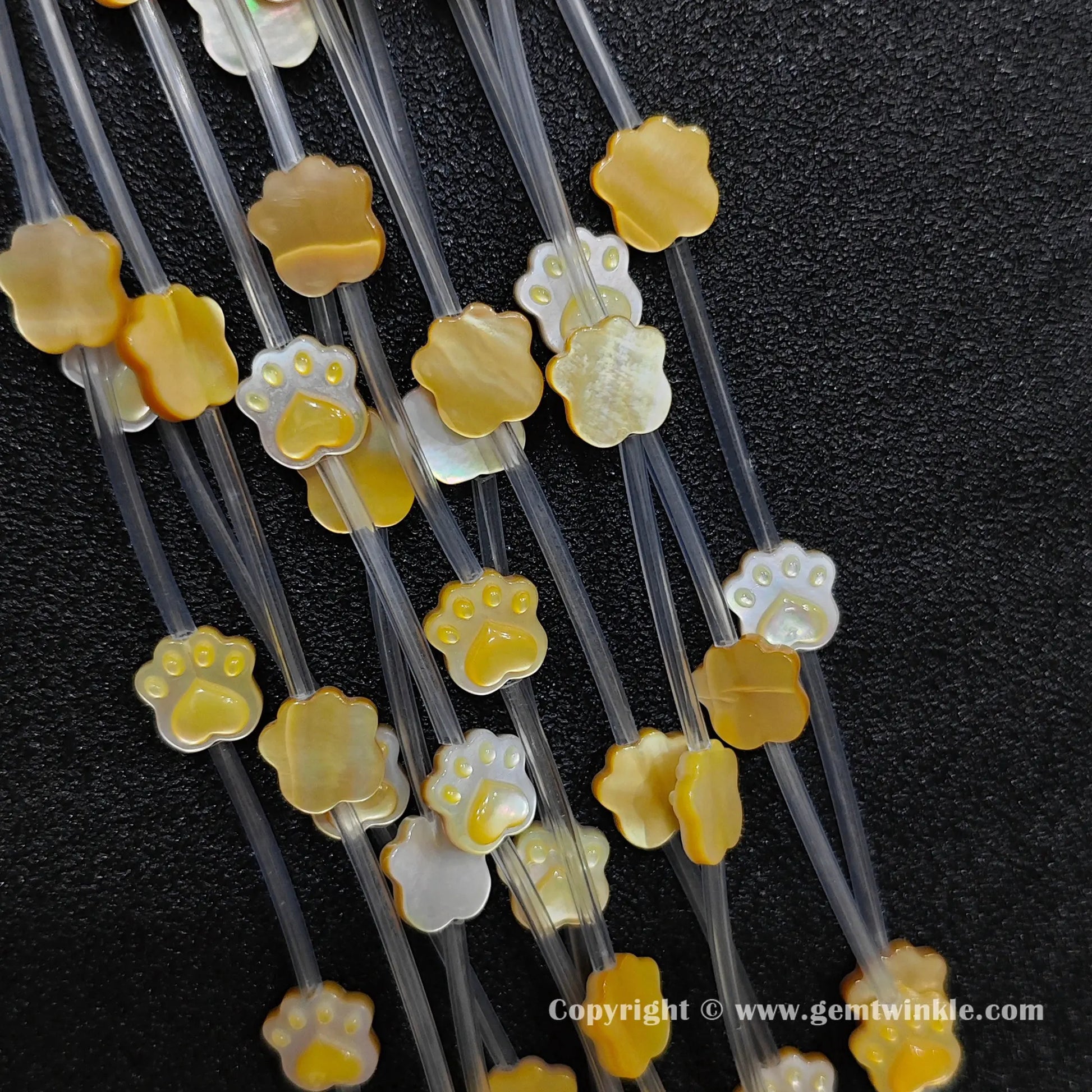 Handheld preview showing 10mm yellow mother of pearl cat paw beads