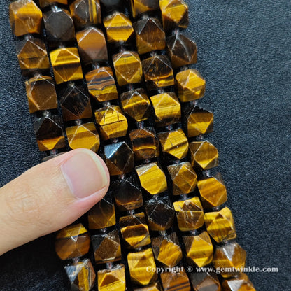 handheld scale view of 12mm faceted yellow tiger eye beads