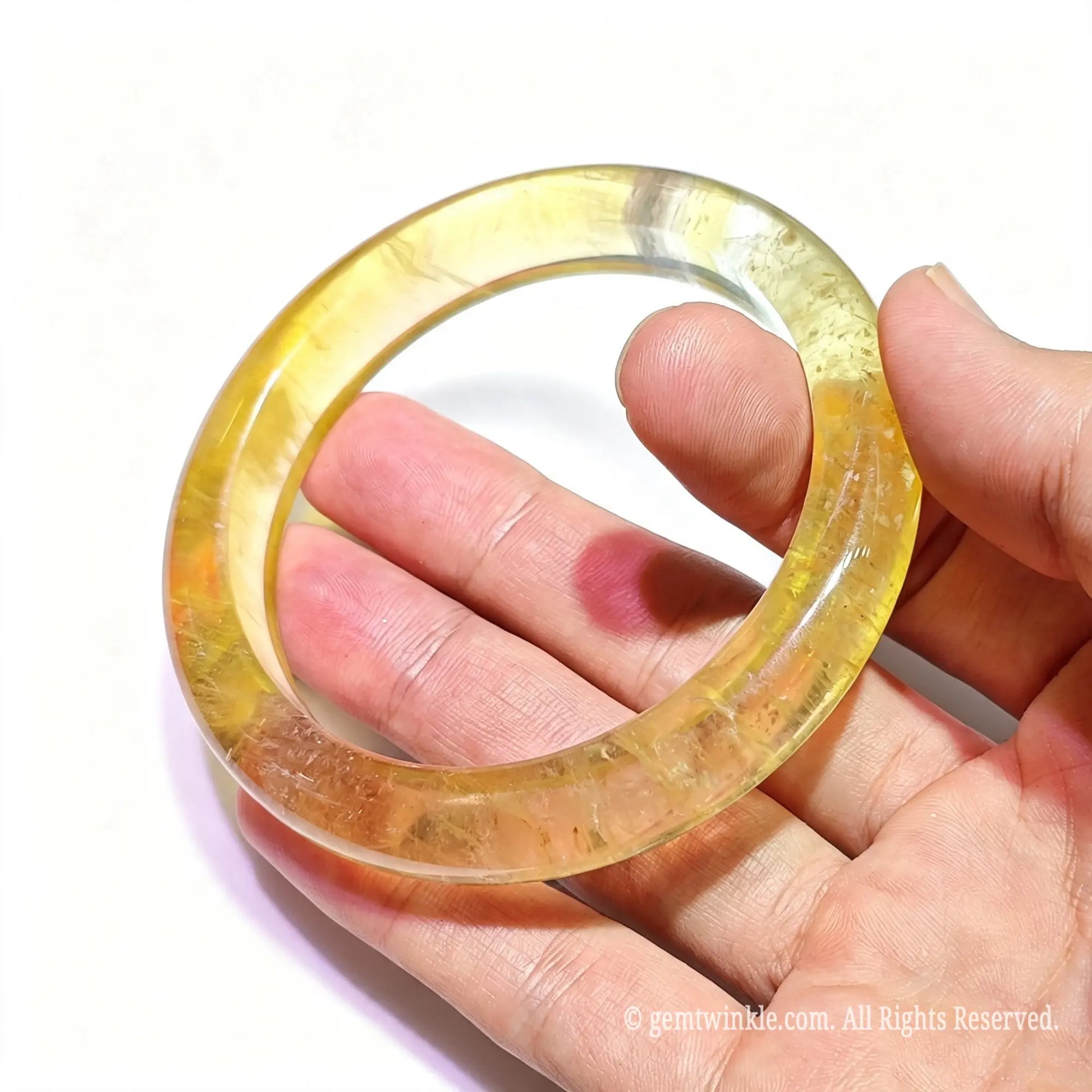 Handpicked yellow fluorite bangle boutique find under studio light showing golden honey tones and natural stone depth