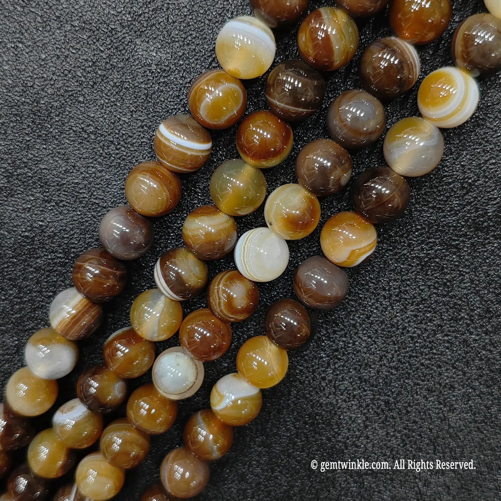 healing crystal beads wholesale featuring glossy color enhanced brown sardonyx lines with sharp espresso and cream parallel ribbon patterns