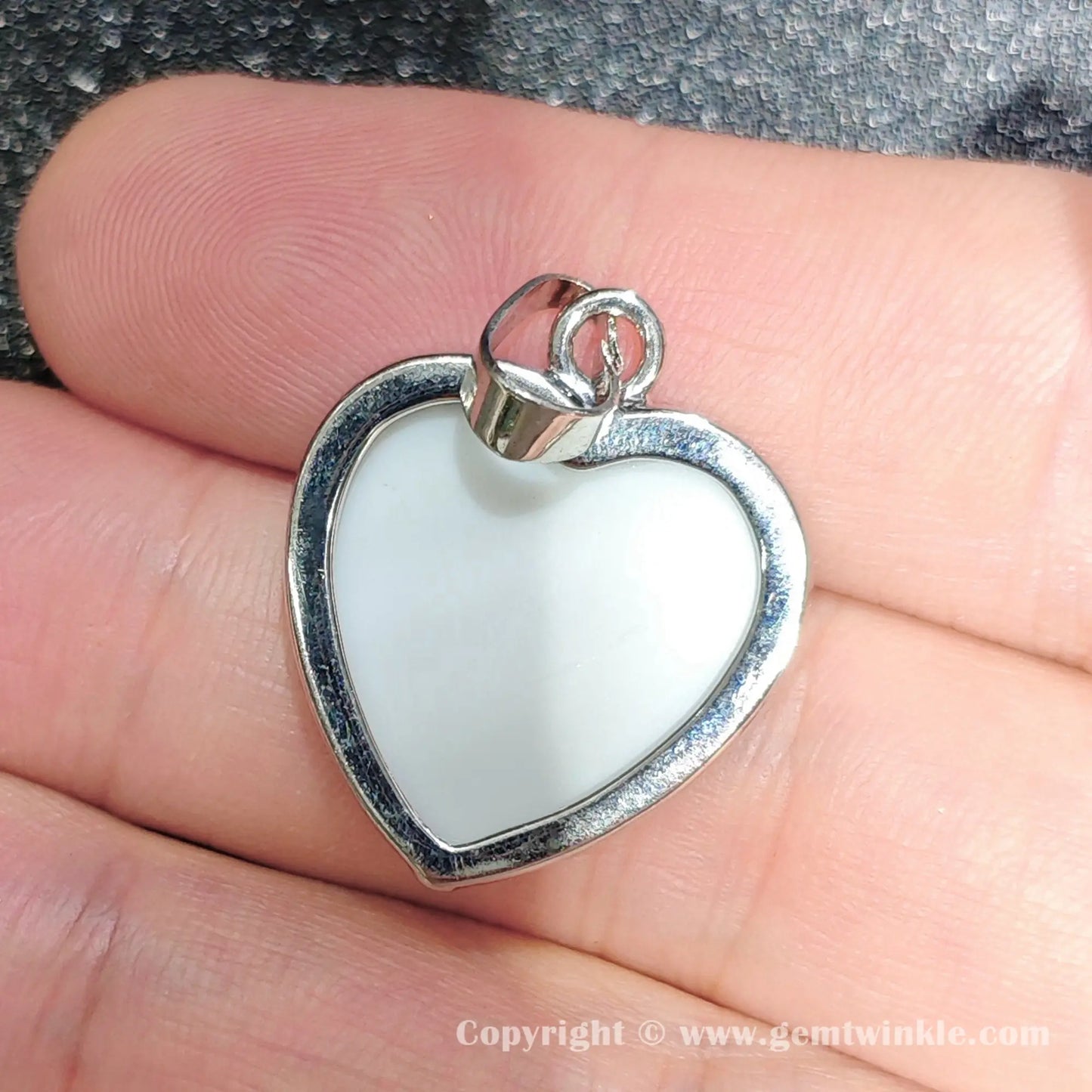 Back view displaying smooth white mother of pearl backing and top alloy bail of 25mm heart charm