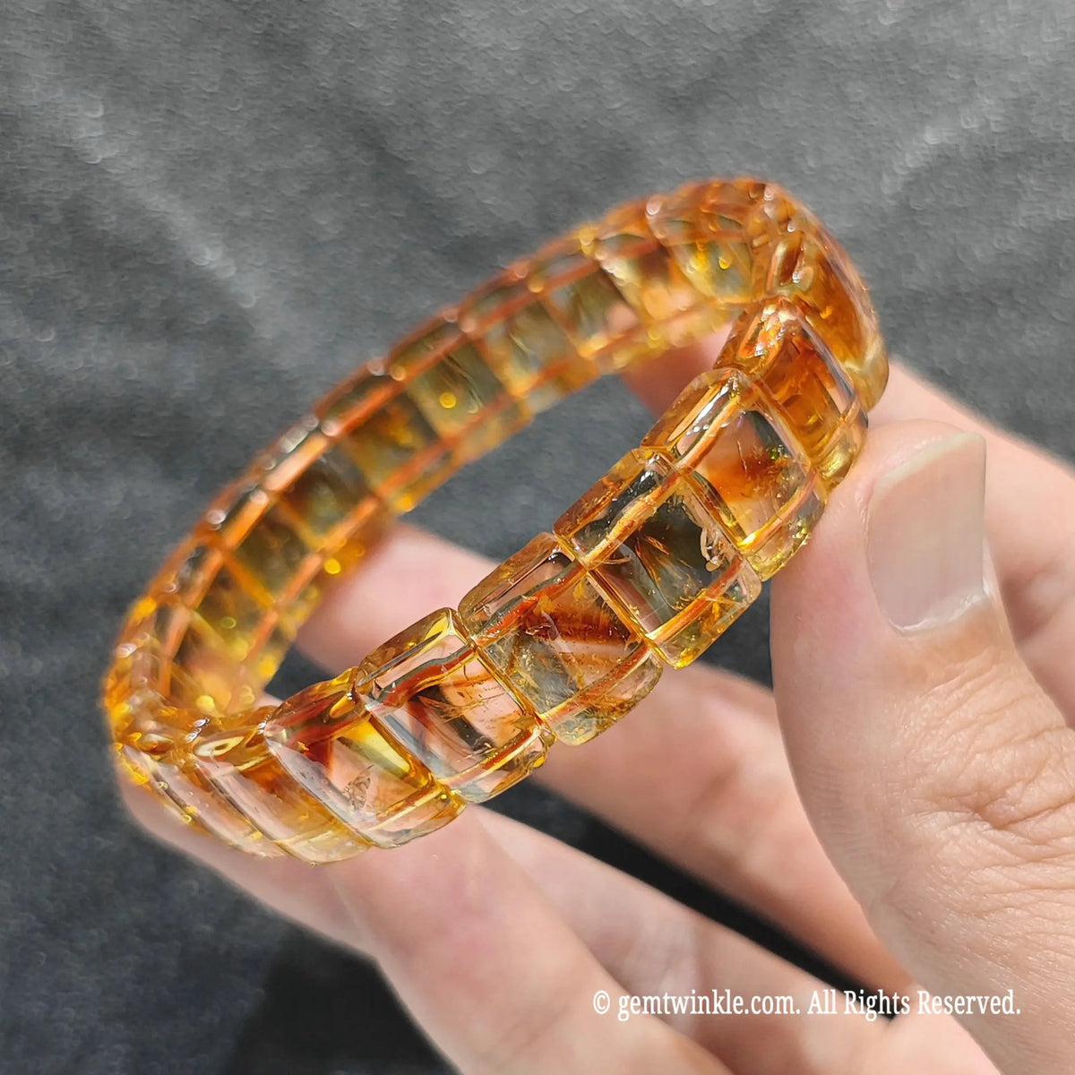 Side view of a heat-enhanced citrine bar cut stacker showing rectangular beads with phantom growth layers