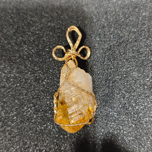 Golden heat-treated citrine rough crystal specimen wrapped in gold-tone craft wire with decorative bail