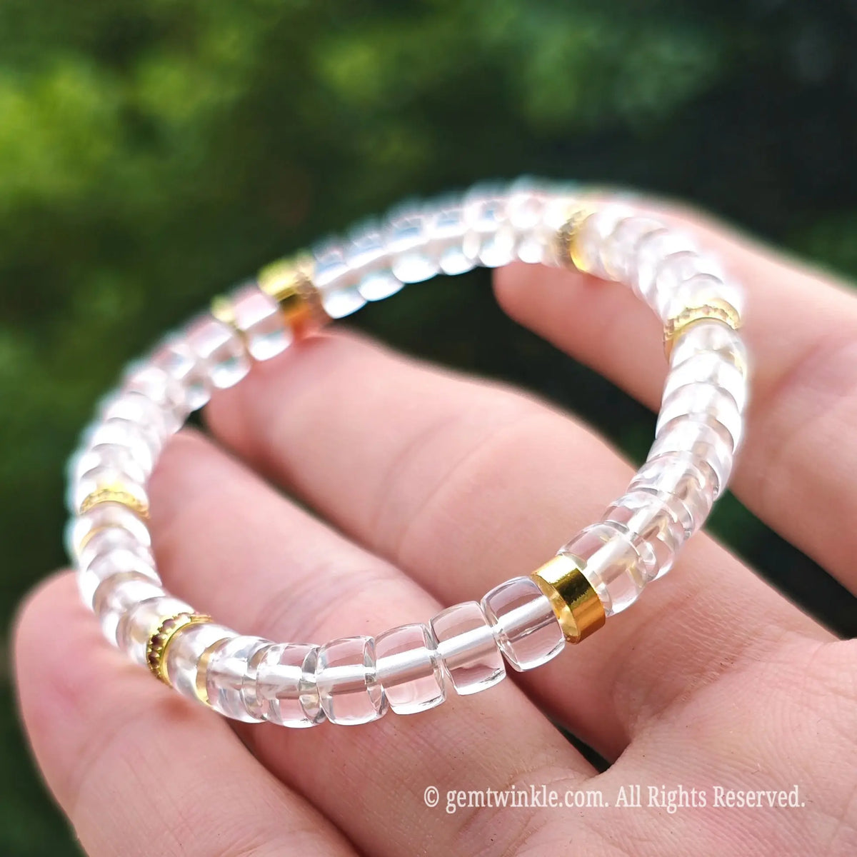 Angled view of a minimalist clear quartz crystal bracelet highlighting its sparkling transparency