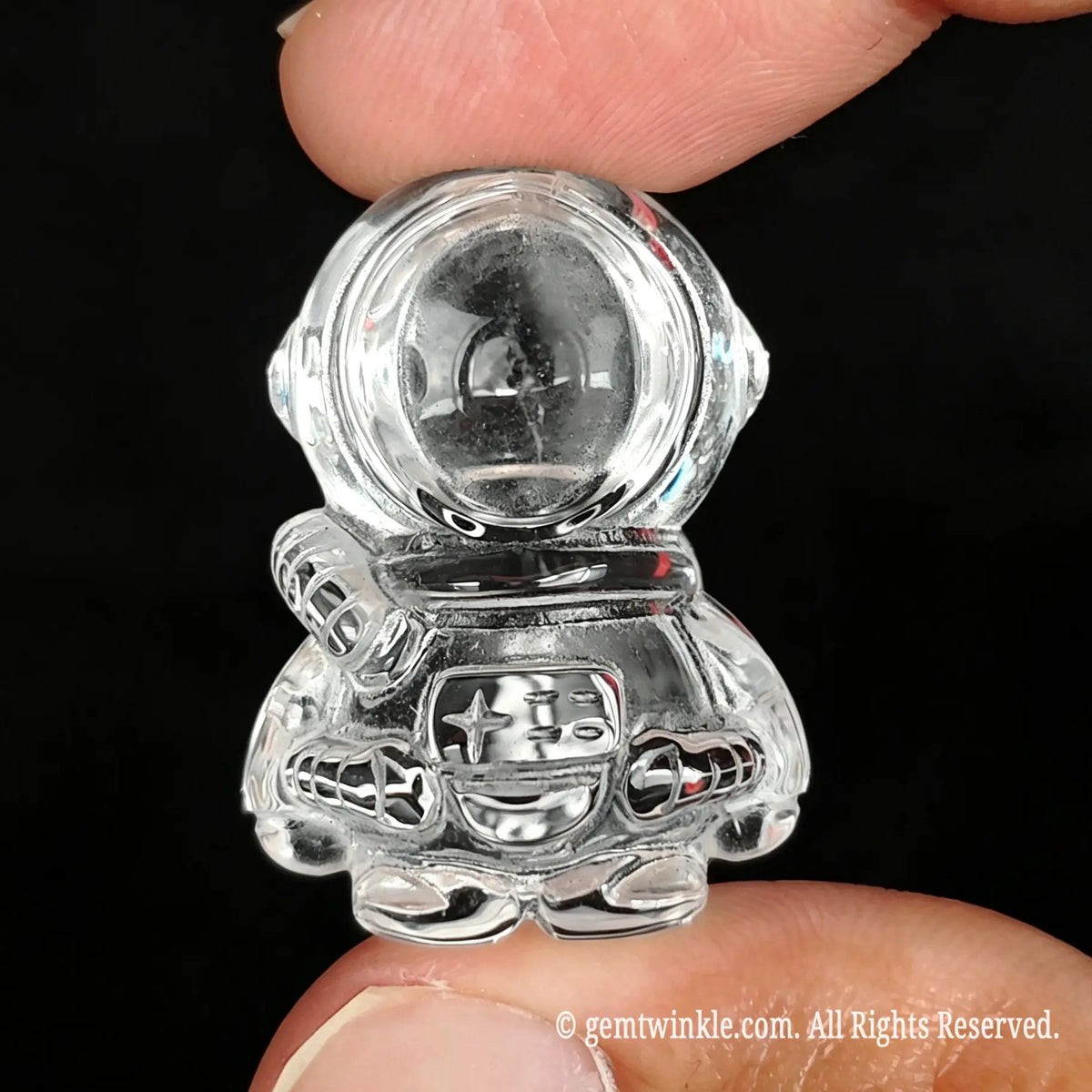 Front preview of clear quartz astronaut carving highlighting optical transparency and suit details