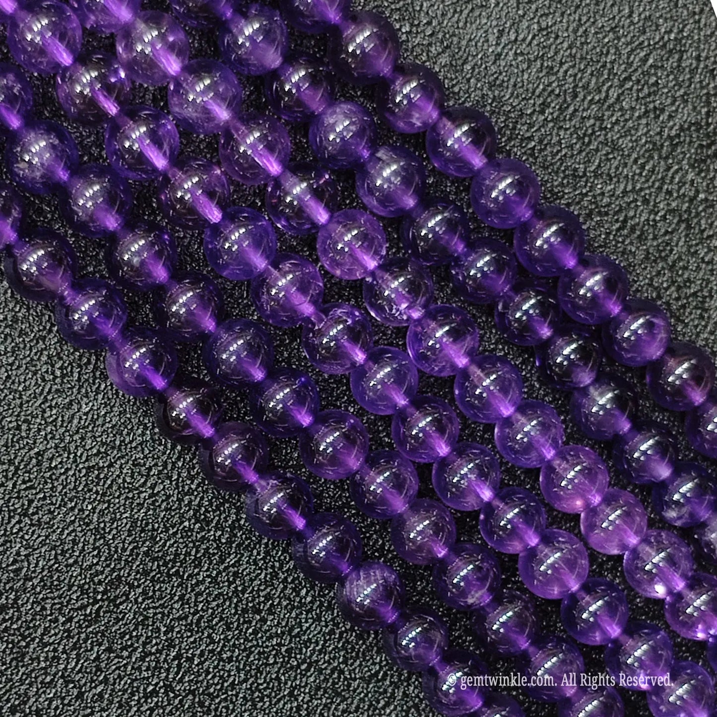 Macro detailed shot of high clarity natural deep purple amethyst gemstone strands showing minimal inner inclusions