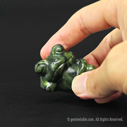 Hand holding a six centimeter funny lazy frog desk pet to demonstrate the physical size scale for crystal wholesale buyers