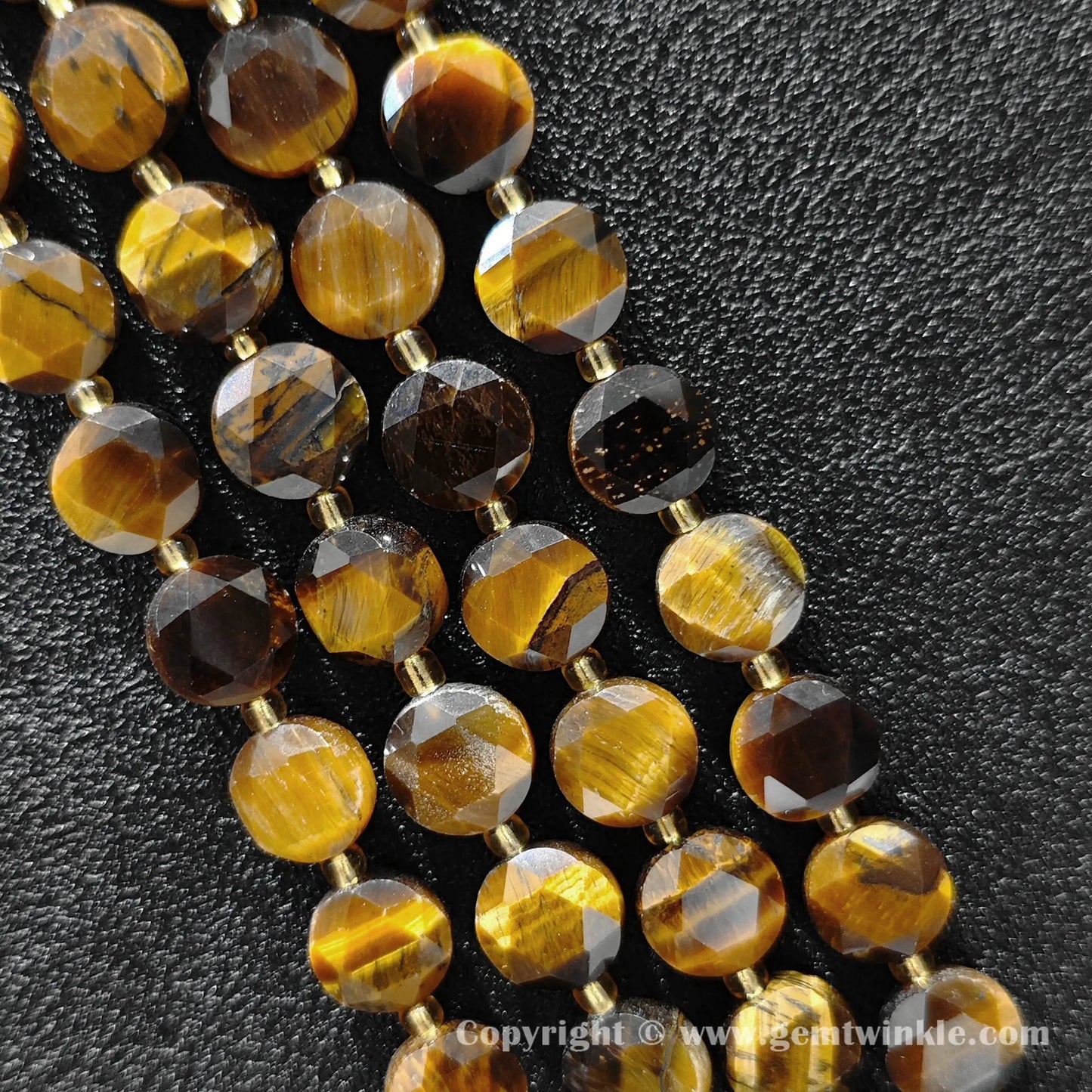 Side view of honey tiger eye star cut flat disc beads showing edge thickness