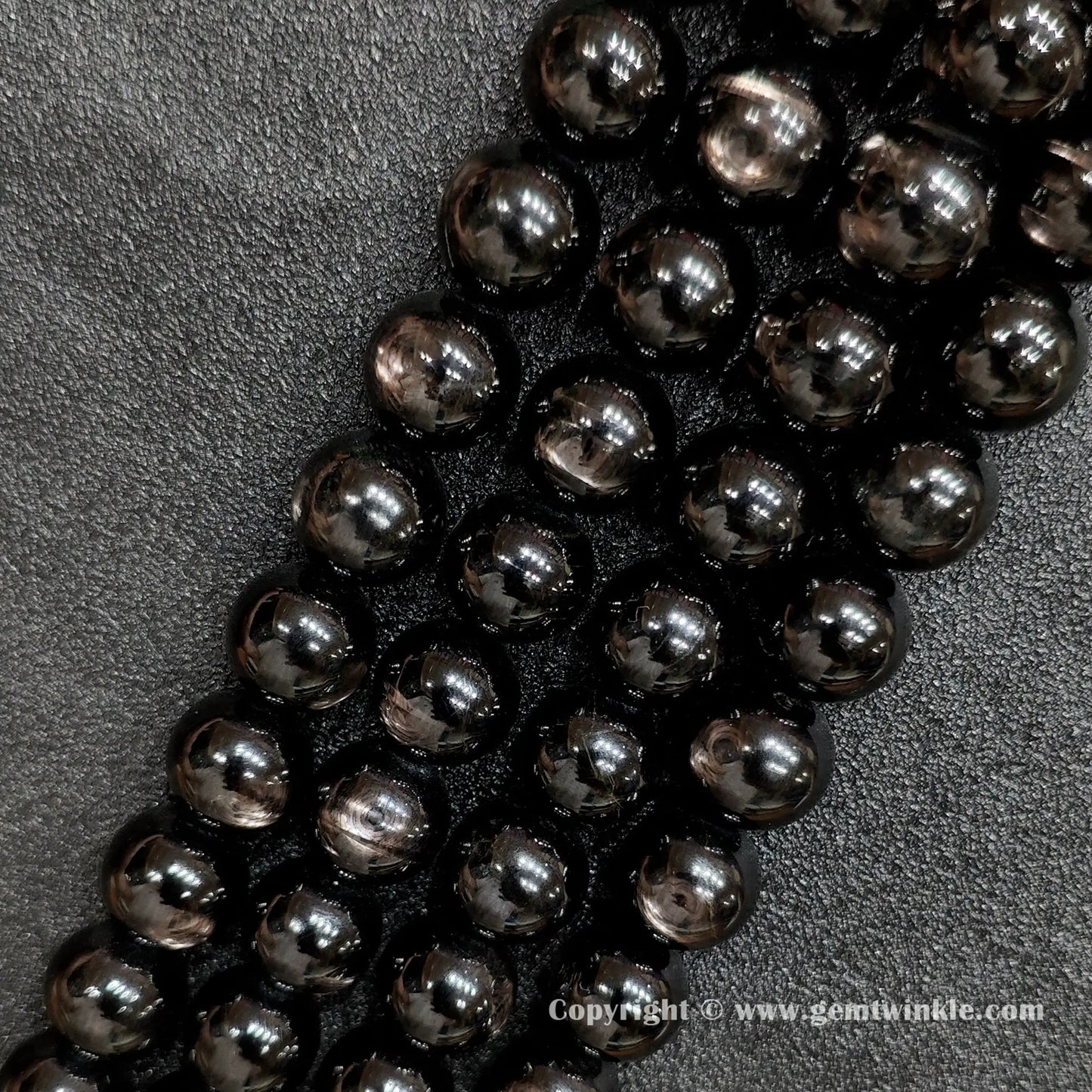 Detailed shot of real B grade golden velvet labradorite crystal beads with natural surface pits and bronze flashes strung on standard jewelry cords