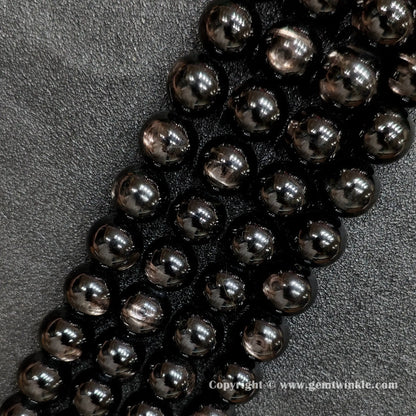 Detailed shot of real B grade golden velvet labradorite crystal beads with natural surface pits and bronze flashes strung on standard jewelry cords