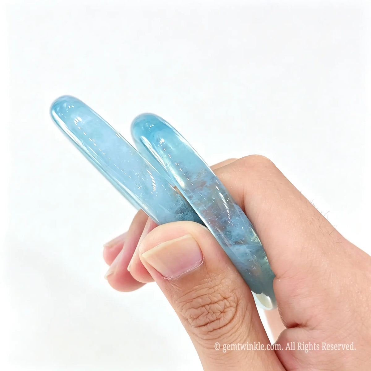 Side profile of smooth polished Aquamarine stone bangle showing solid round thickness