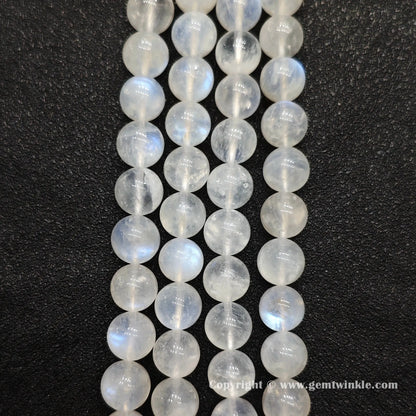 Perspective view of ice fractured blue flash moonstone round beads displaying polished surface across sizes