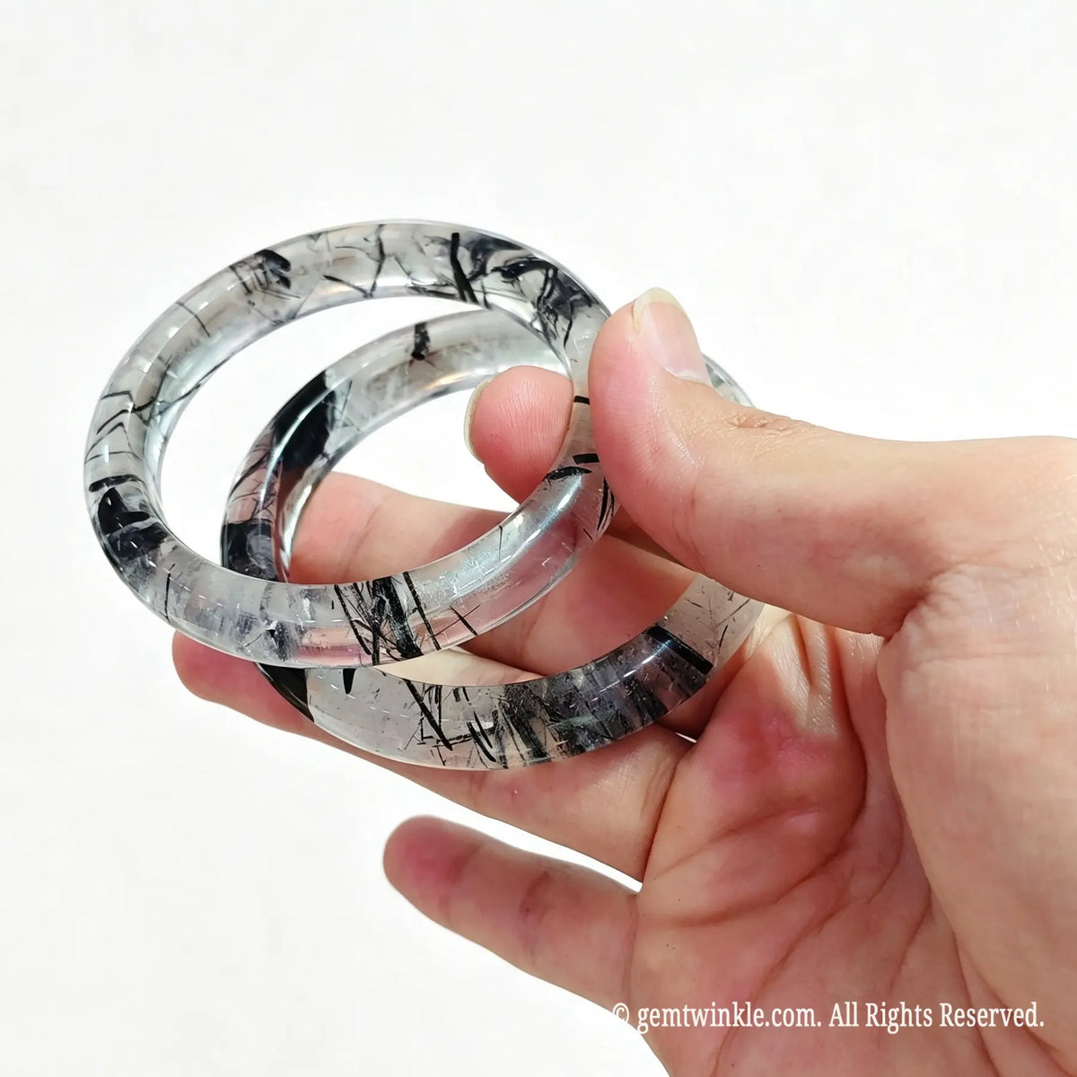 Pair of ice clear tourmalinated quartz wristbands showcasing multiple price tiers and custom inner diameter sizes