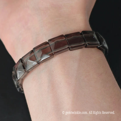 Ice obsidian 11mm square bead pyramid faceted stretch bracelet styled on wrist displaying geometric profile