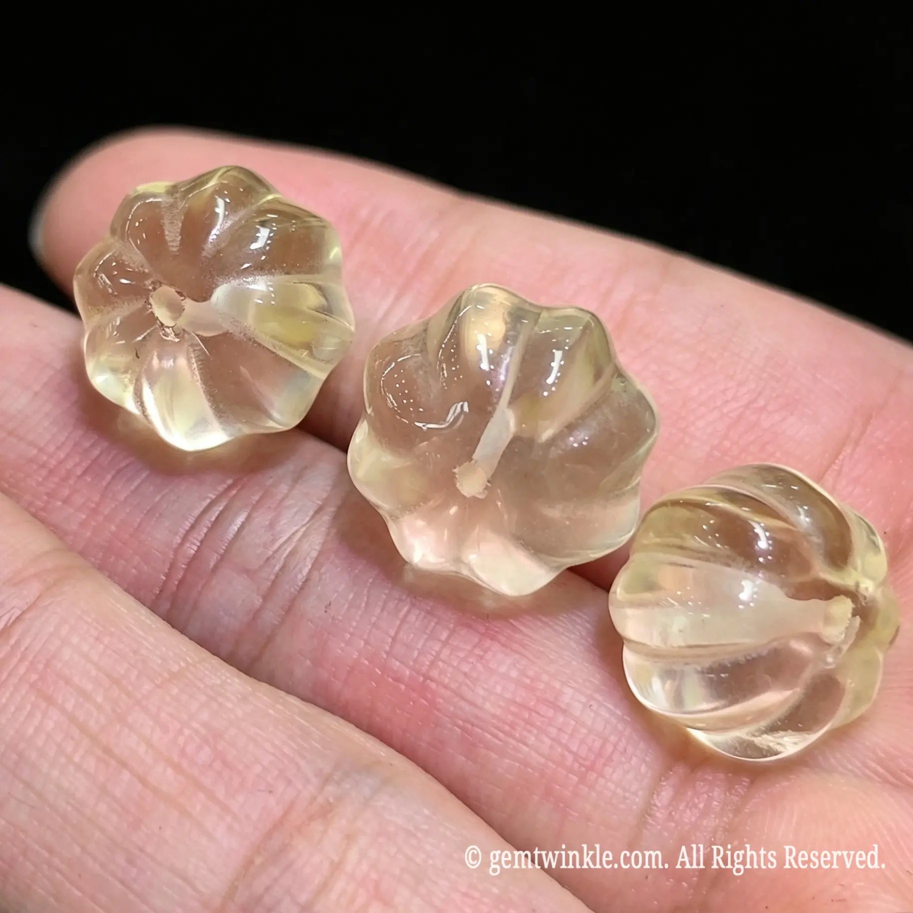Side angle of 12mm citrine pumpkin loose bead highlighting smooth flute polish and lemon yellow clarity