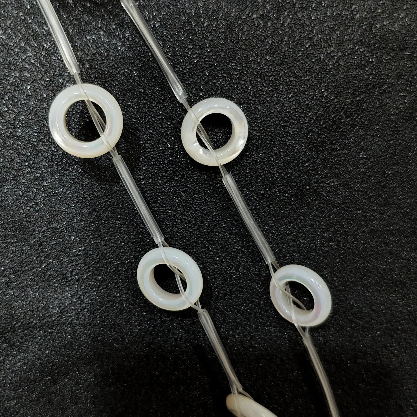 Laminated white mother of pearl donut ring beads full strand view