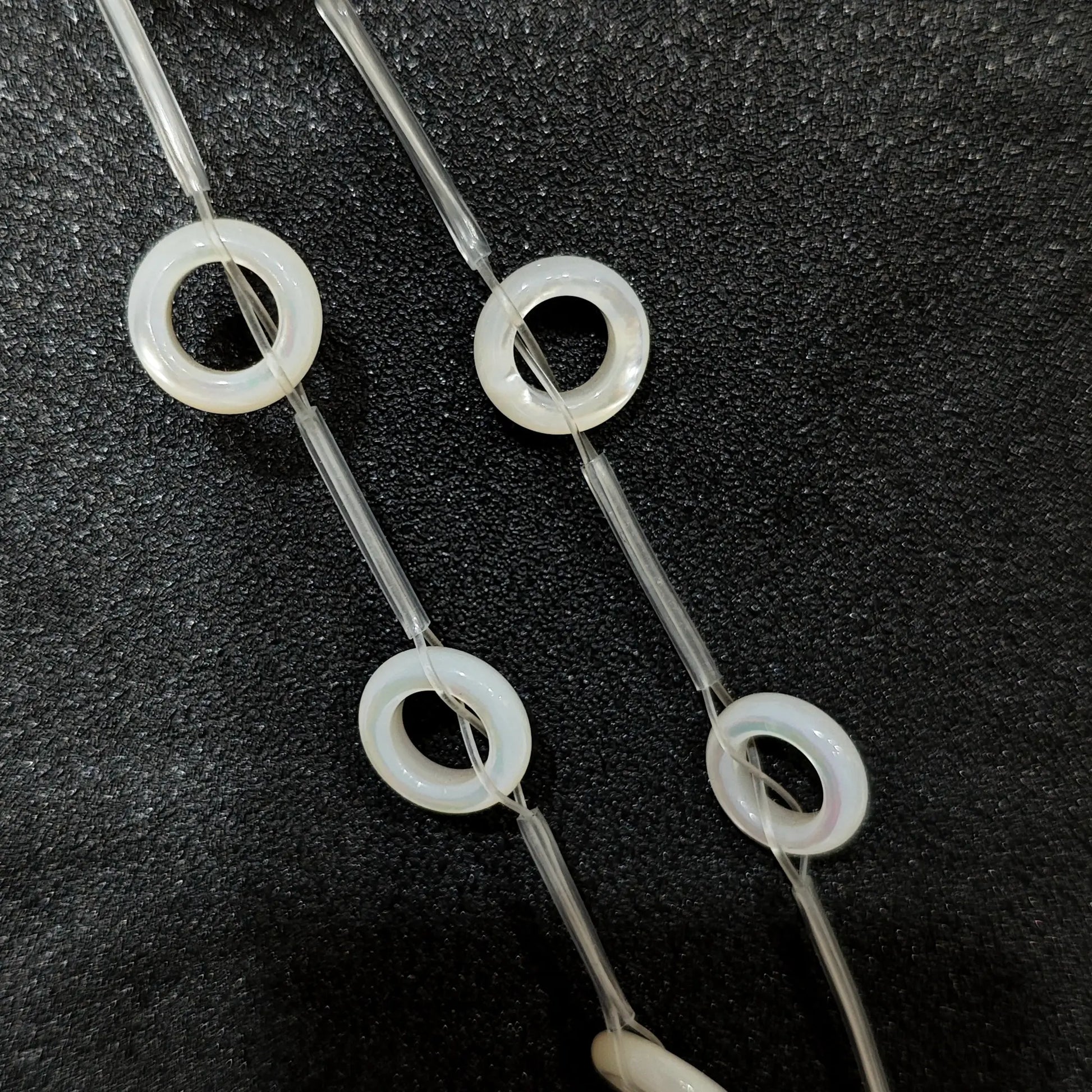 Laminated white mother of pearl donut ring beads full strand view
