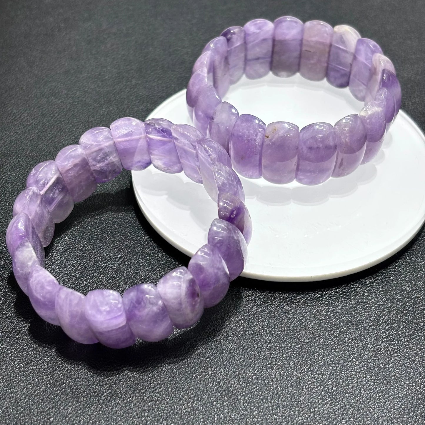 Closeup of Natural Lavender Amethyst Moon Bead Bracelet, highlighting the unique banding and translucence of the stone