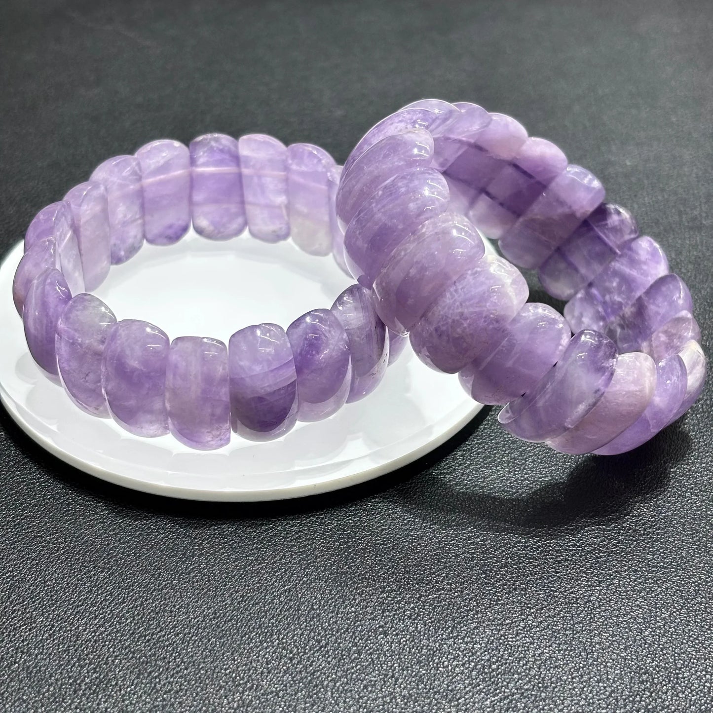  Two Natural Lavender Amethyst Moon Bead Bracelets stacked on white plate, showcasing smooth texture and pastel purple color