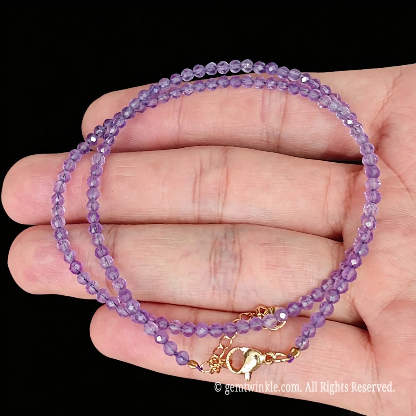 lavender amethyst faceted micro bead necklace loop with gold tone extender chain in hand