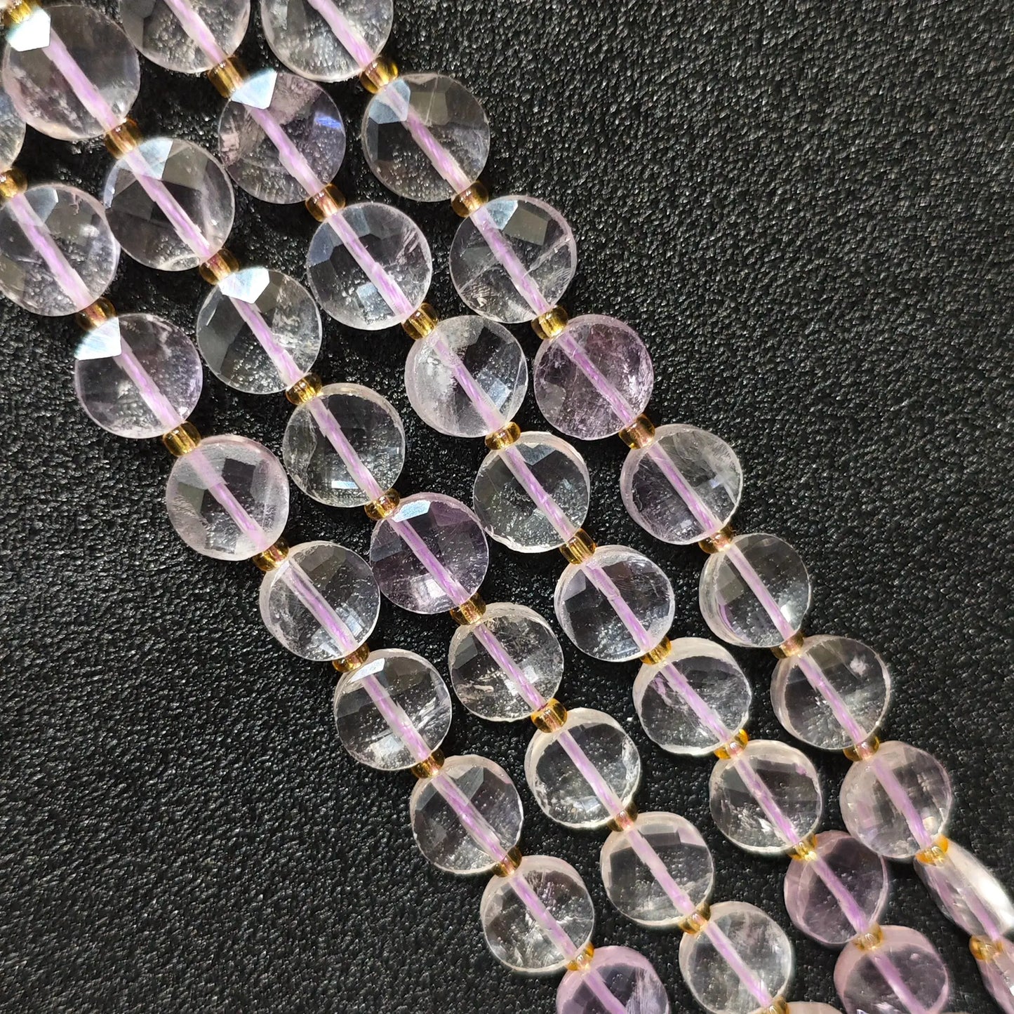 Strands of high clarity lavender amethyst faceted coin beads showing clear light purple quartz