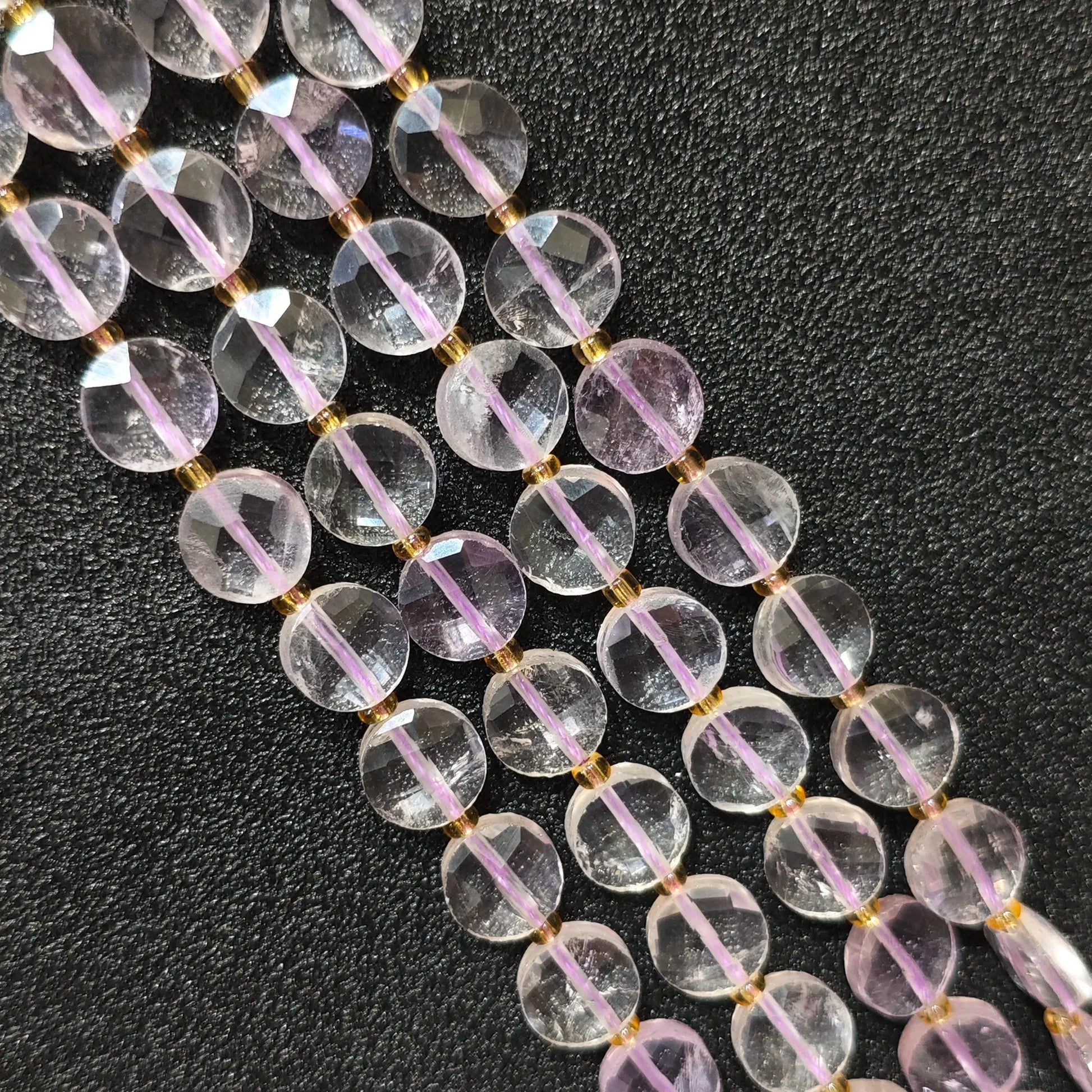 Strands of high clarity lavender amethyst faceted coin beads showing clear light purple quartz