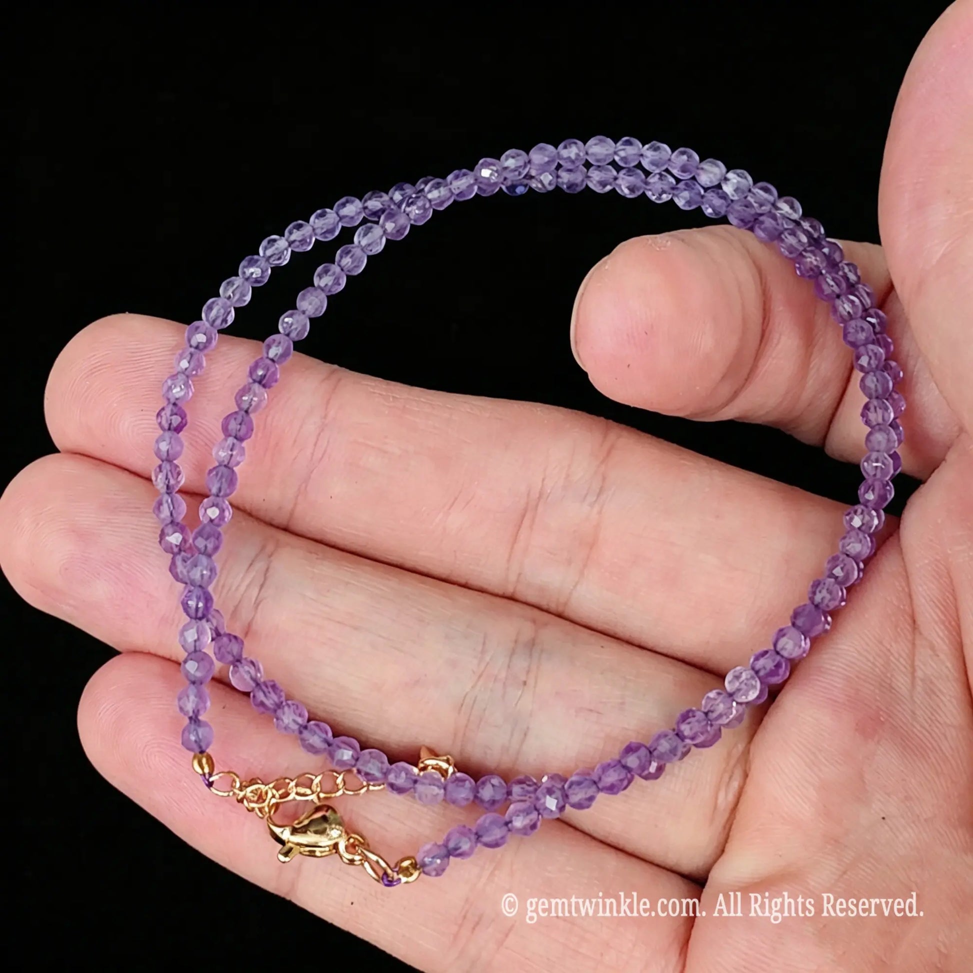 side view of lavender quartz micro faceted bead necklace resting across fingers