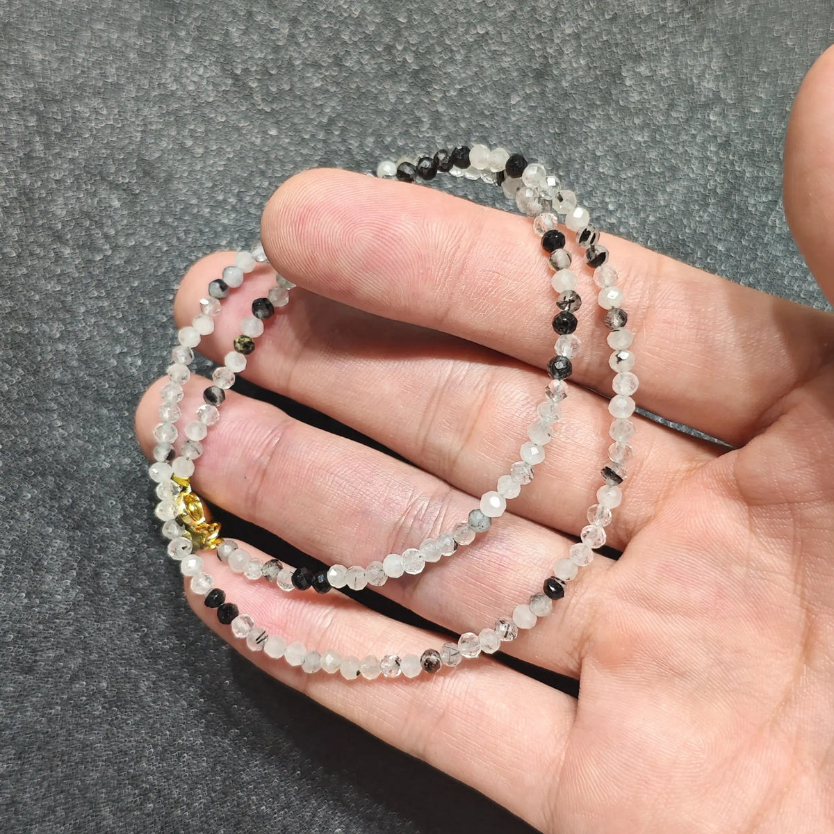Coiled 3mm faceted black rutilated quartz gemstone necklace suited for boutique store displays and layering