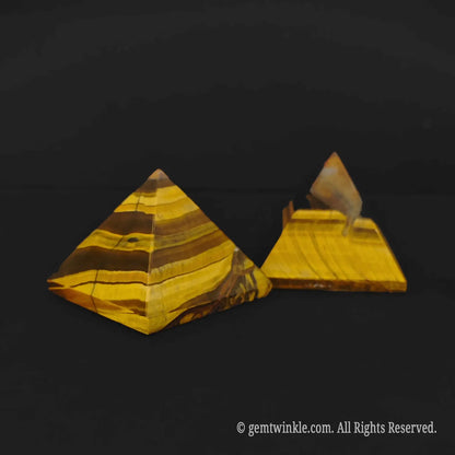 Side view of two 4cm gold tigers eye pyramids highlighting distinct brown and yellow mineral lines