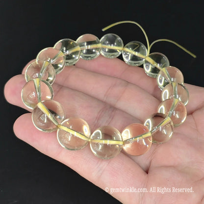 lemon quartz round bead stretch bracelet shown in open hand