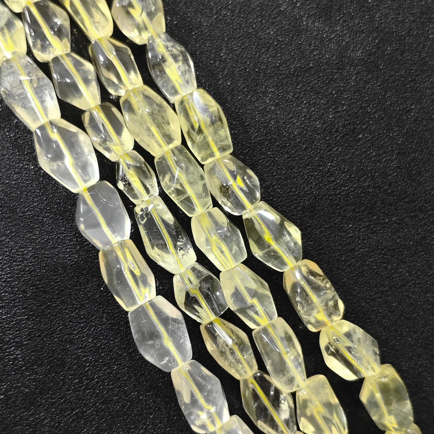 Strand of color-enhanced lemon quartz faceted freeform barrel beads 15mm