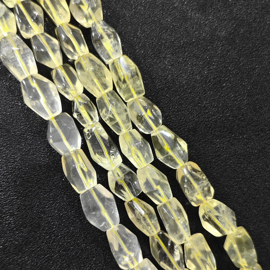 Strand of color-enhanced lemon quartz faceted freeform barrel beads 15mm