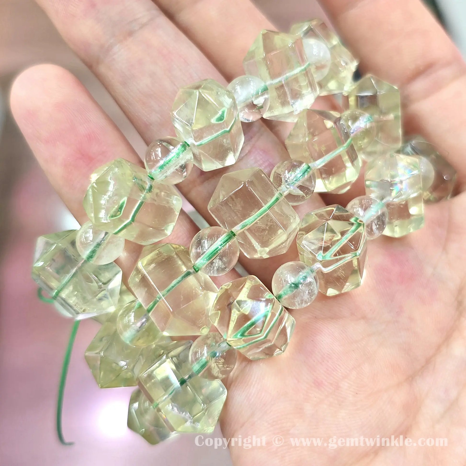 Close up view of 16mm precision carved lemon quartz double terminated point facets and spacer beads