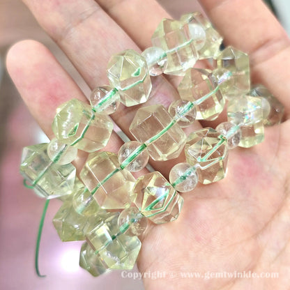 Close up view of 16mm precision carved lemon quartz double terminated point facets and spacer beads