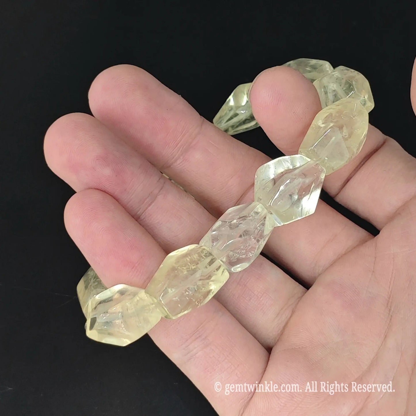 top view of light yellow lemon quartz freeform bead stretch bangle on hand