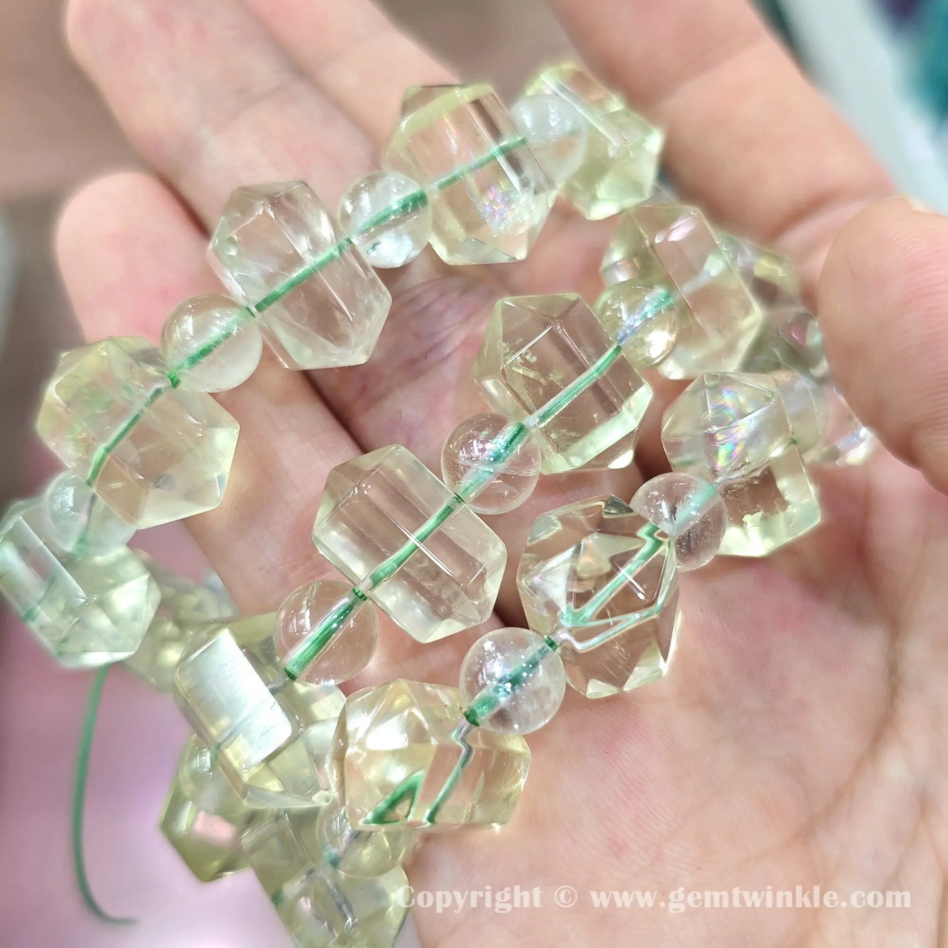 Handheld view highlighting transparent pale yellow color enhanced lemon quartz bead structure