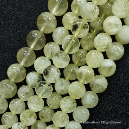 Close up of natural lemon citrine loose beads showing heavy inclusions and white matrix structures for rustic jewelry