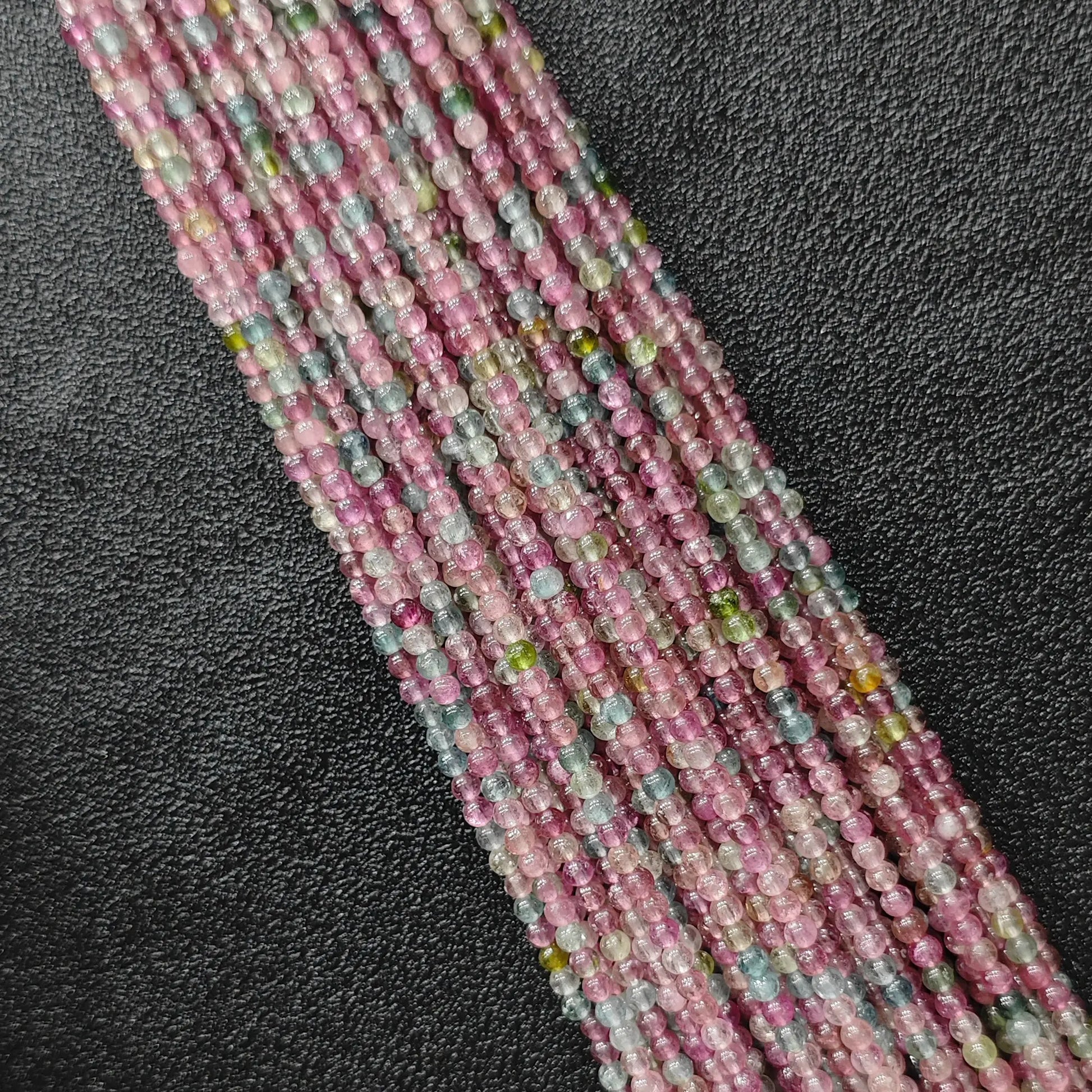 Light color pastel multi color tourmaline 2.5mm tiny gemstone beads close up view