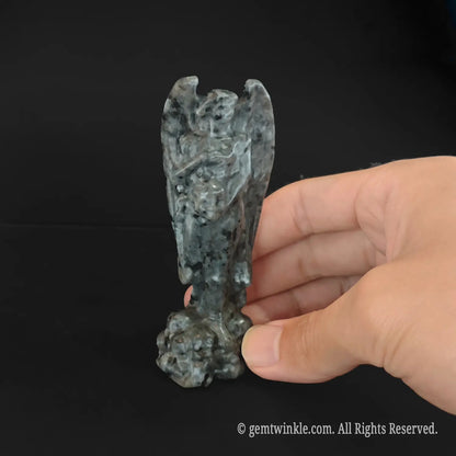grey spotted stone lucifer sculpture