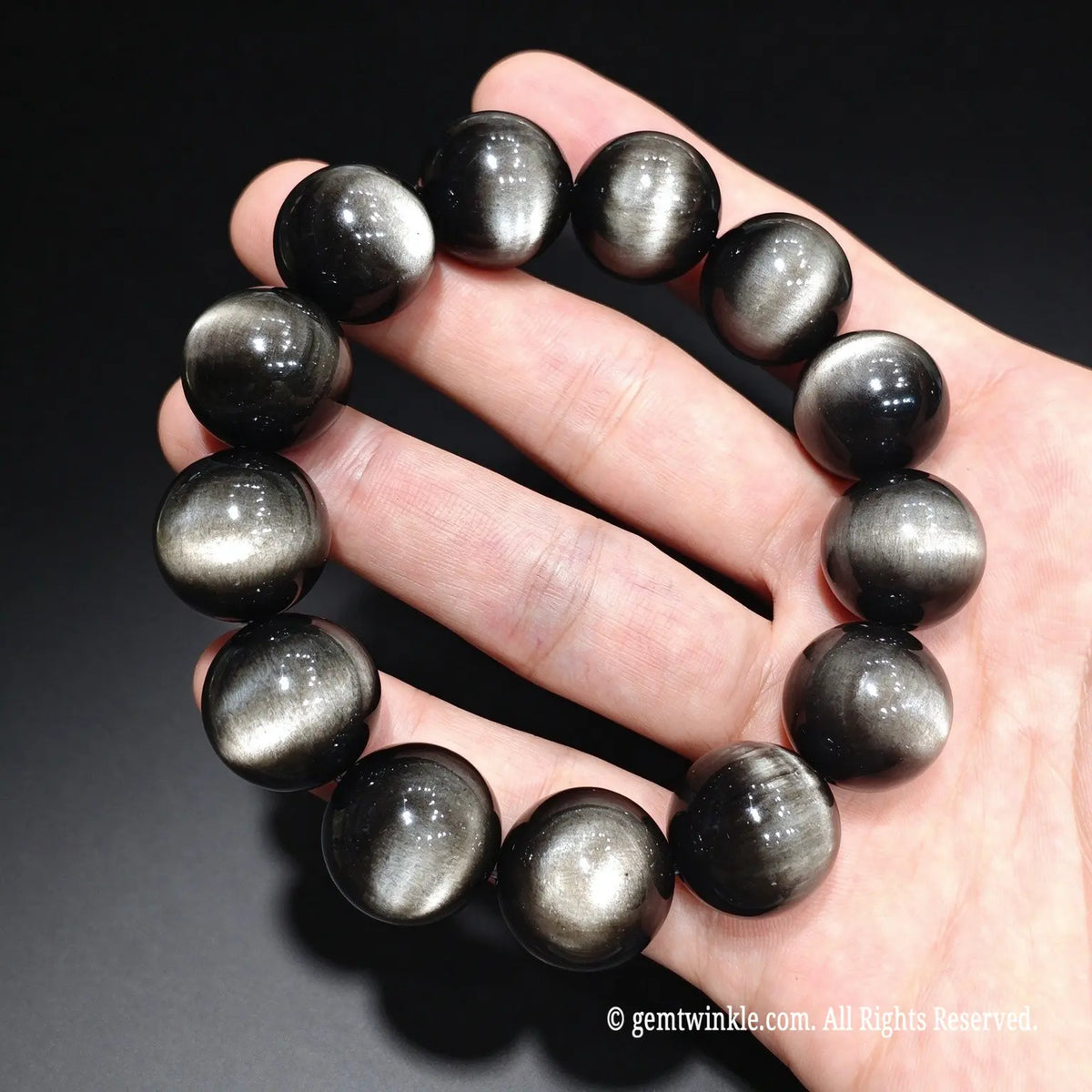 Luxury men's silver sheen obsidian statement bracelet displaying bright silvery luster under direct light