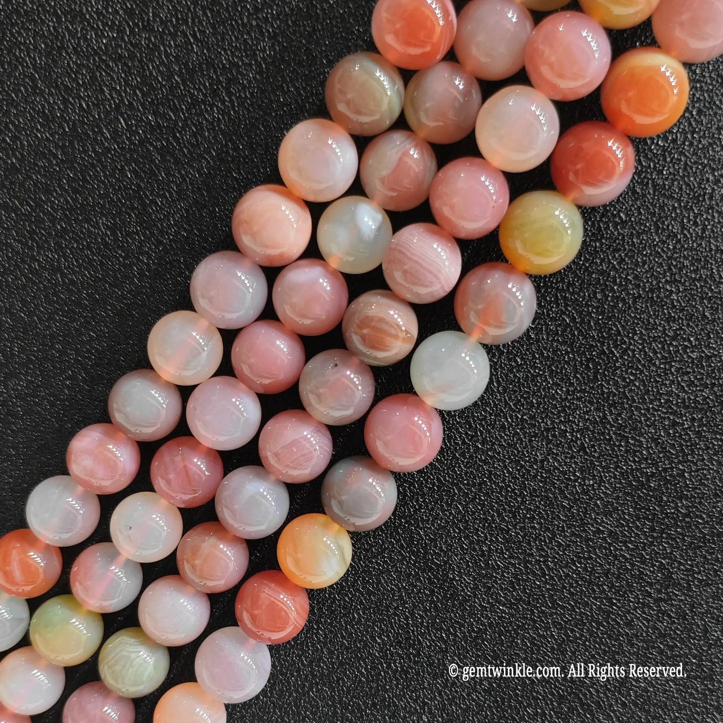 Three bulk strands of macaron toned yanyuan agate crystal loose beads showing rich pink and cream color variations
