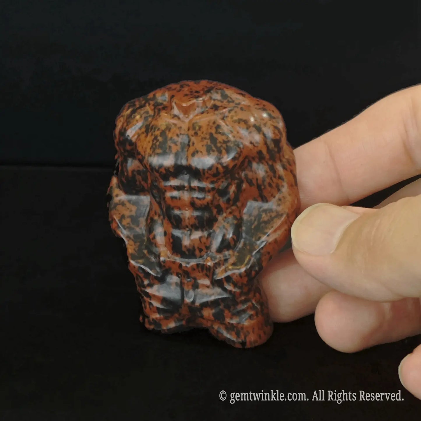 Carved mahogany obsidian crystal male torso figurine showing detailed muscular man abs