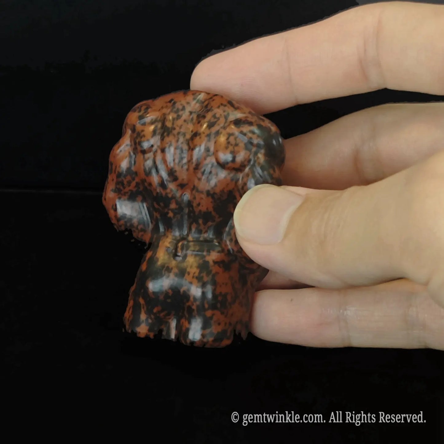 Back details of carved mahogany obsidian muscular man statue highlighting strong shoulder and back muscles