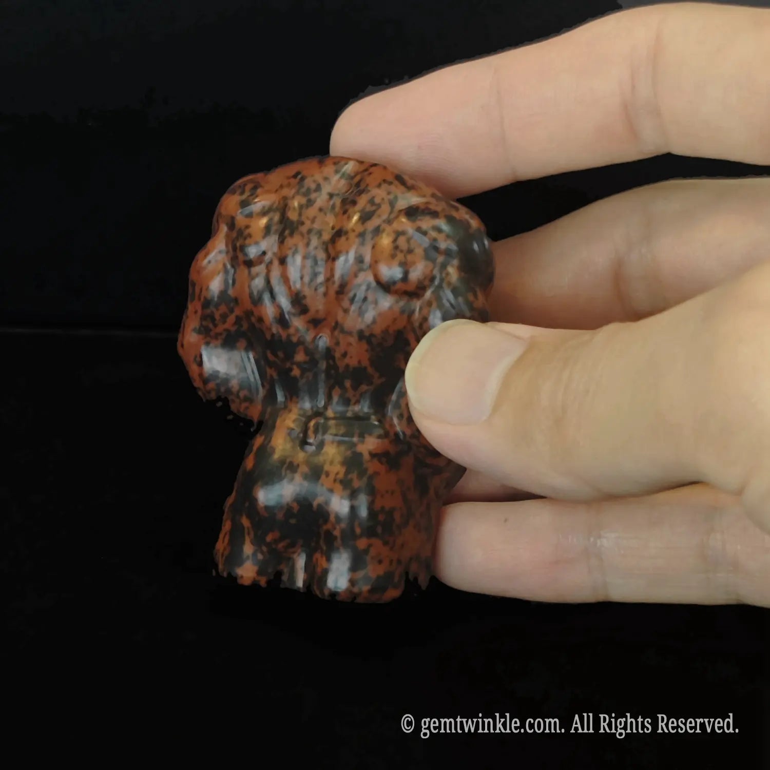 Back details of carved mahogany obsidian muscular man statue highlighting strong shoulder and back muscles