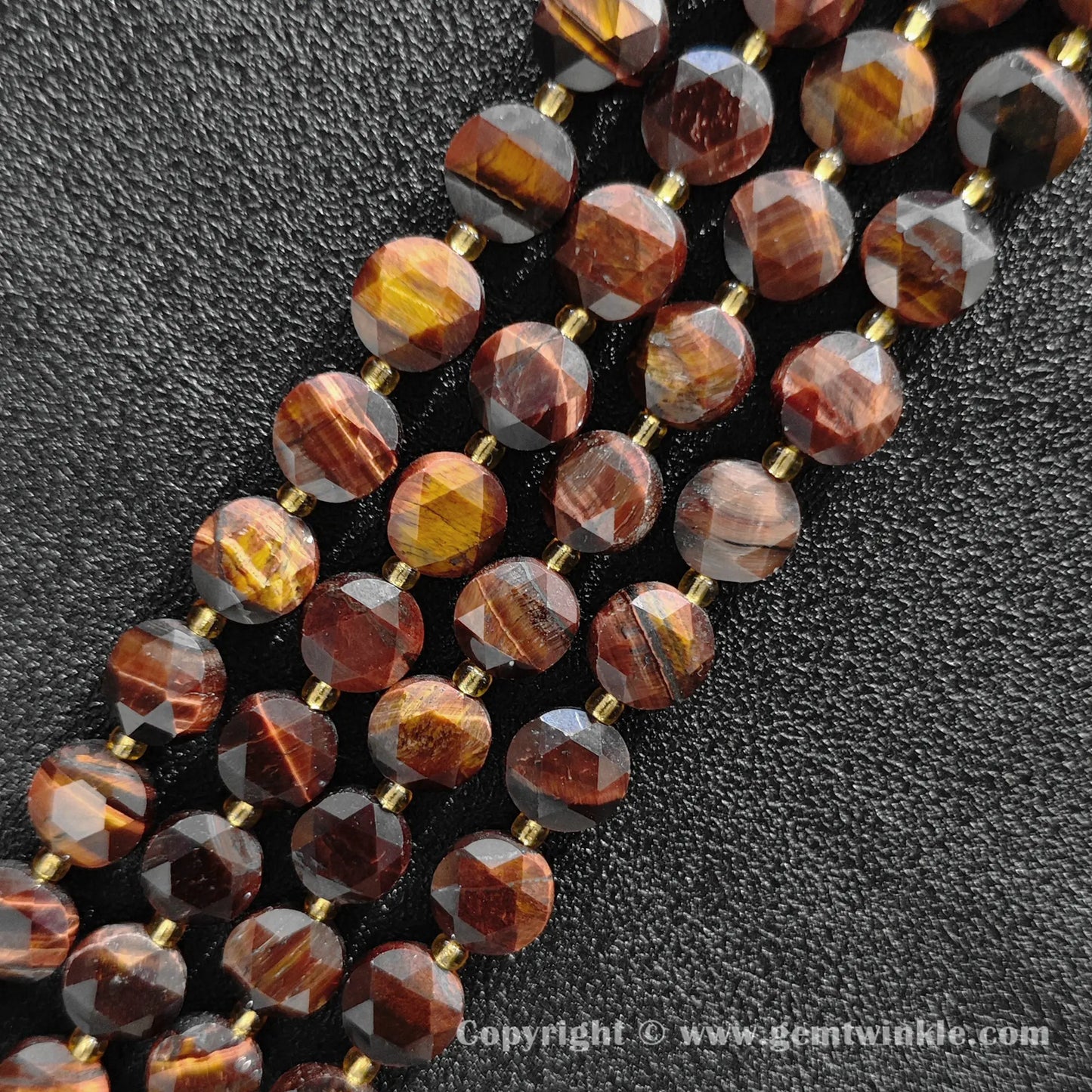 Close up view of mahogany red tiger eye star faceted flat wheel beads