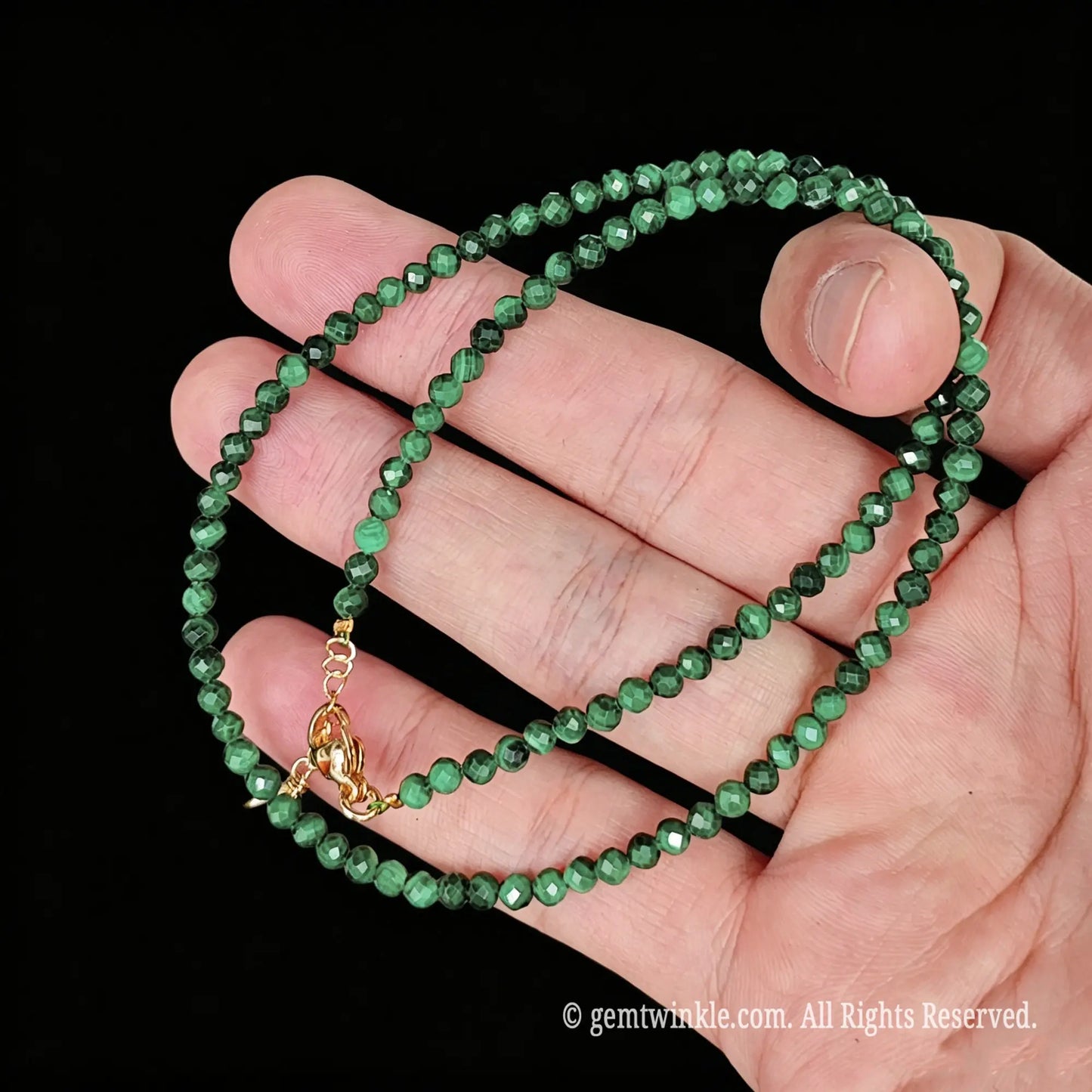 untreated malachite faceted bead necklace loop with gold tone extender chain and charm tag