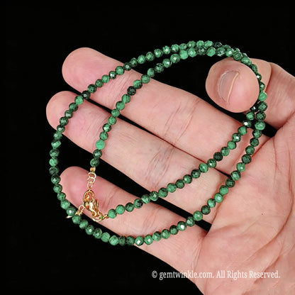 untreated malachite faceted bead necklace loop with gold tone extender chain and charm tag