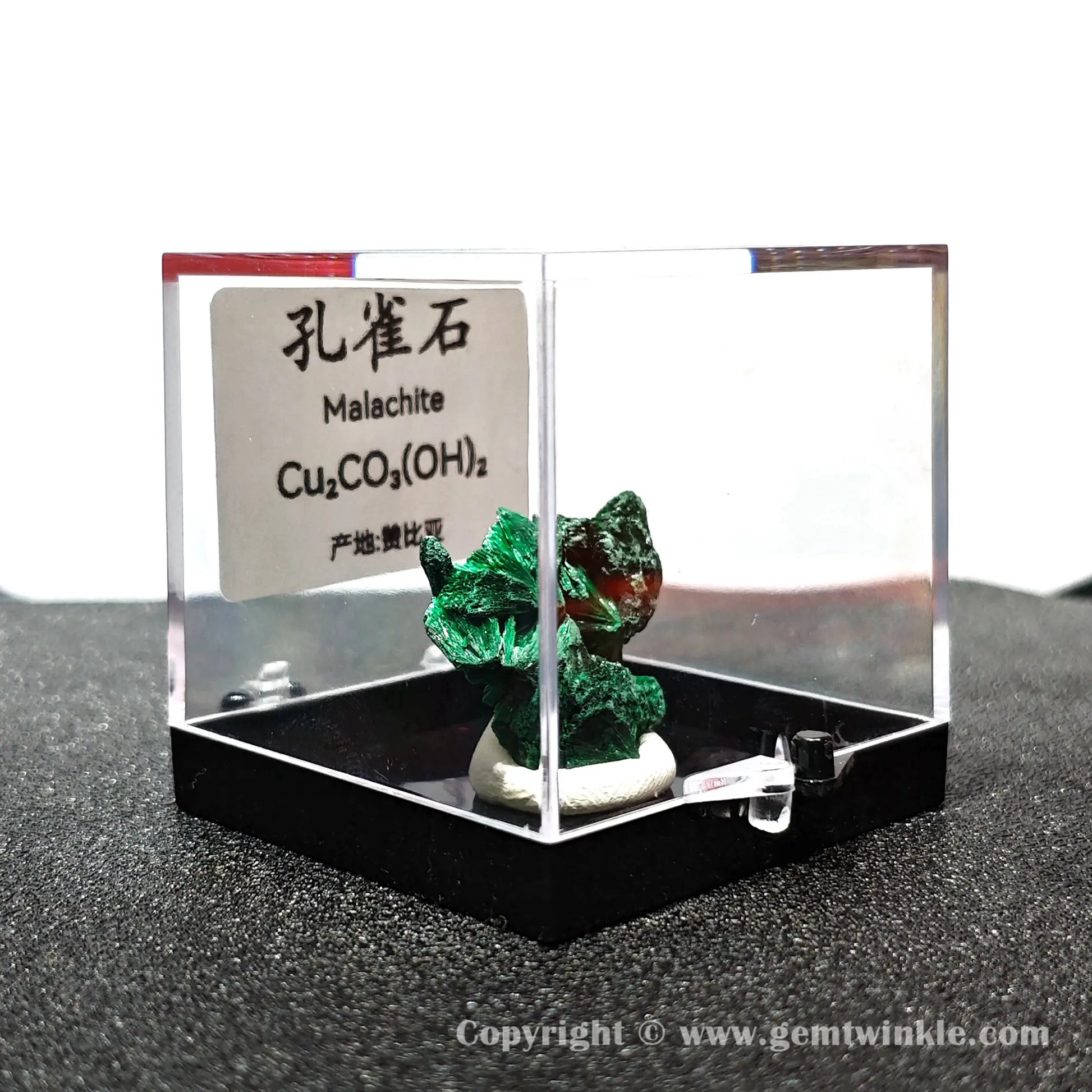 Angled right perspective highlighting rear malachite growth texture and secure black pedestal base mount